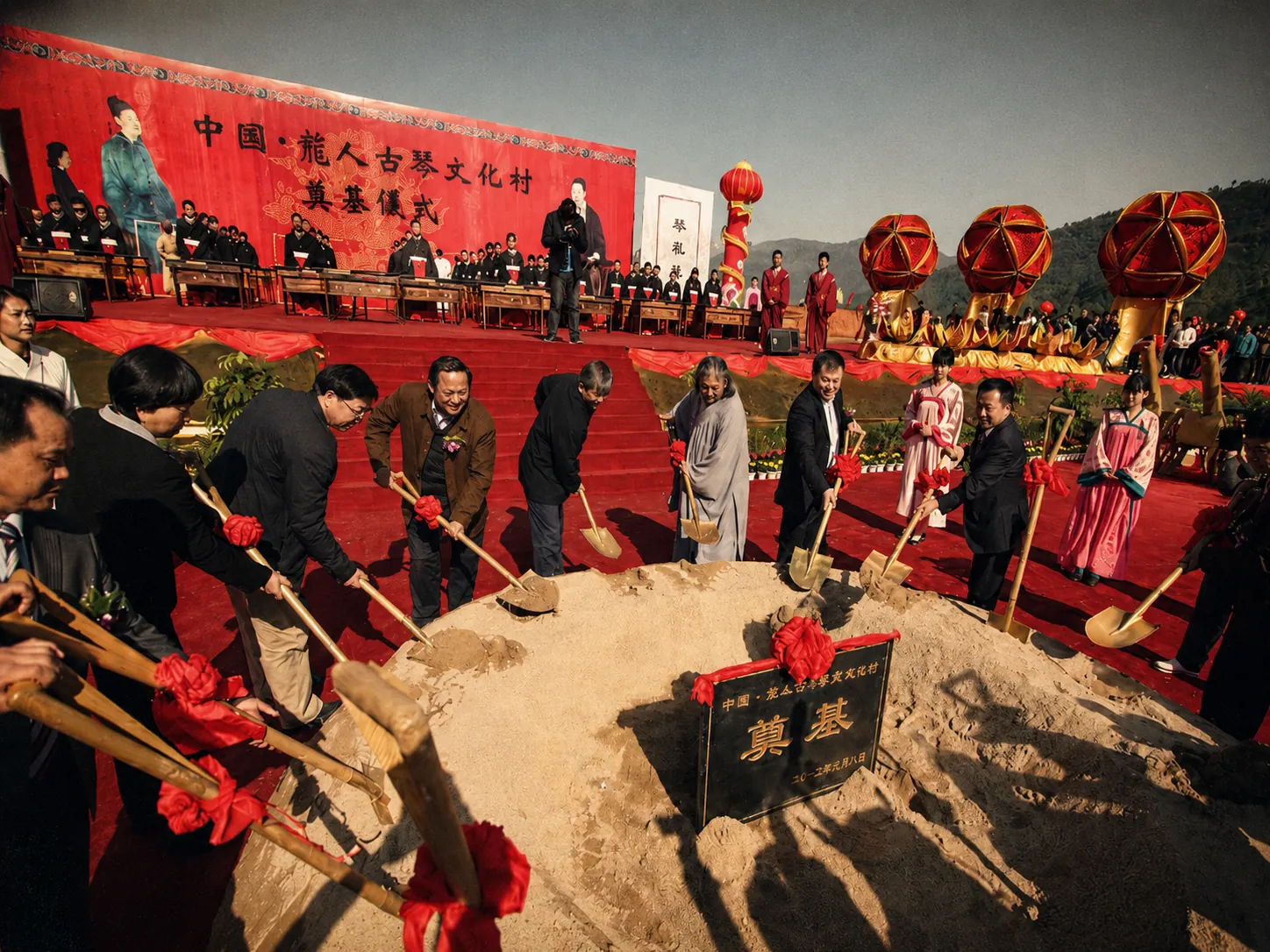 龙人古琴文化村奠基仪式场景，多人共同执锹培土